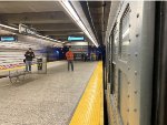 Transit fans get ready to record and photograph the Holiday Train, consisting of Arnines, depart 86th Street Station on the Q Line 